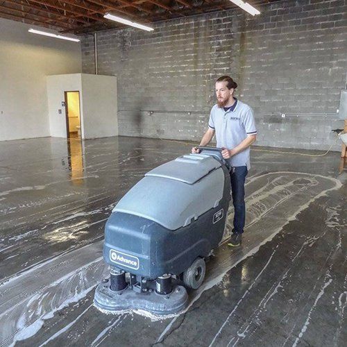 Man Cleaning the Floor — Medford, OR — Sanitech Building Maintenance