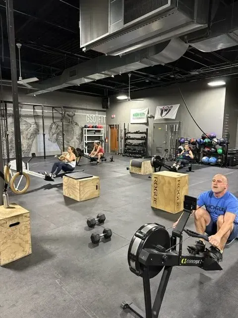 A group of people are doing exercises in a gym.
