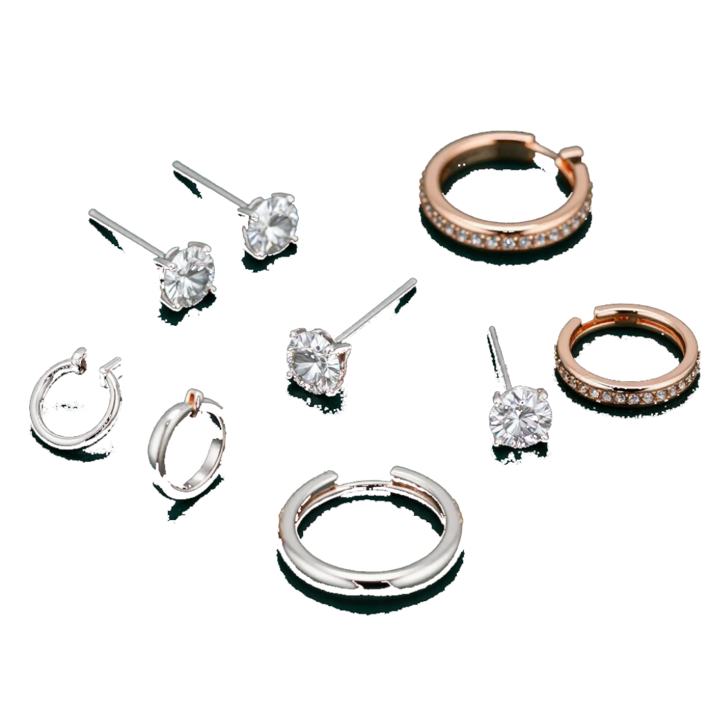 A collection of silver and rose gold stud and hoop earrings with clear stones arranged on a reflective surface.