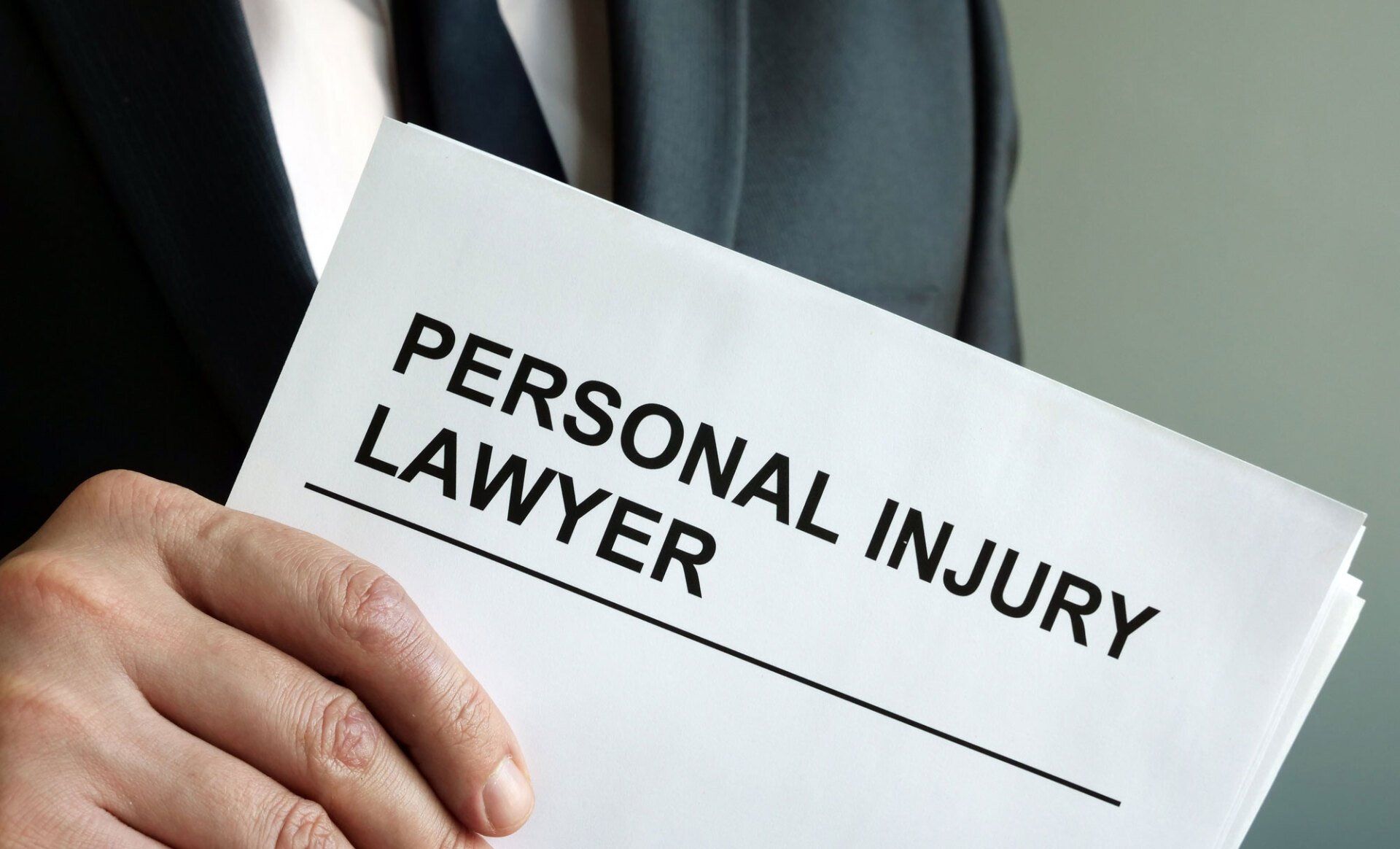 Personal Injury Lawyer Holding Paper — Goshen, NY — Owen Law Firm PLLC