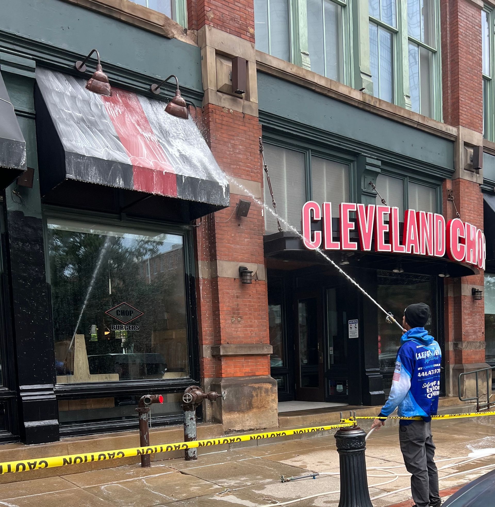 Man power washing the exterior of the