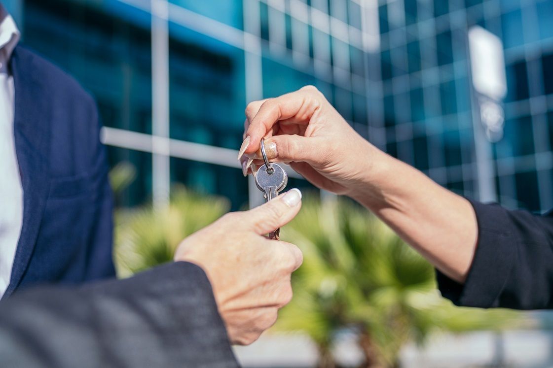 Woman is Handing a Key to a Man – Los Angeles, CA – Roca Lock & Key, Inc.