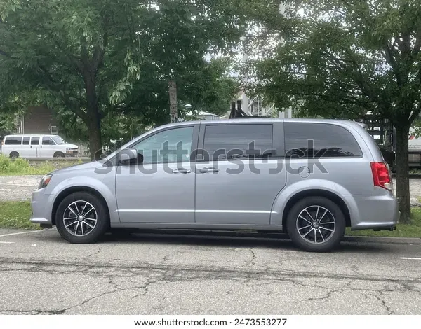 Black Genesis G70 sedan parked on a street at dusk.