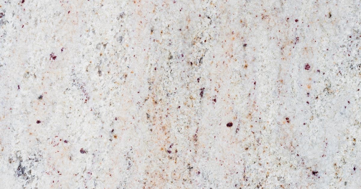 A close up of a white granite counter top.