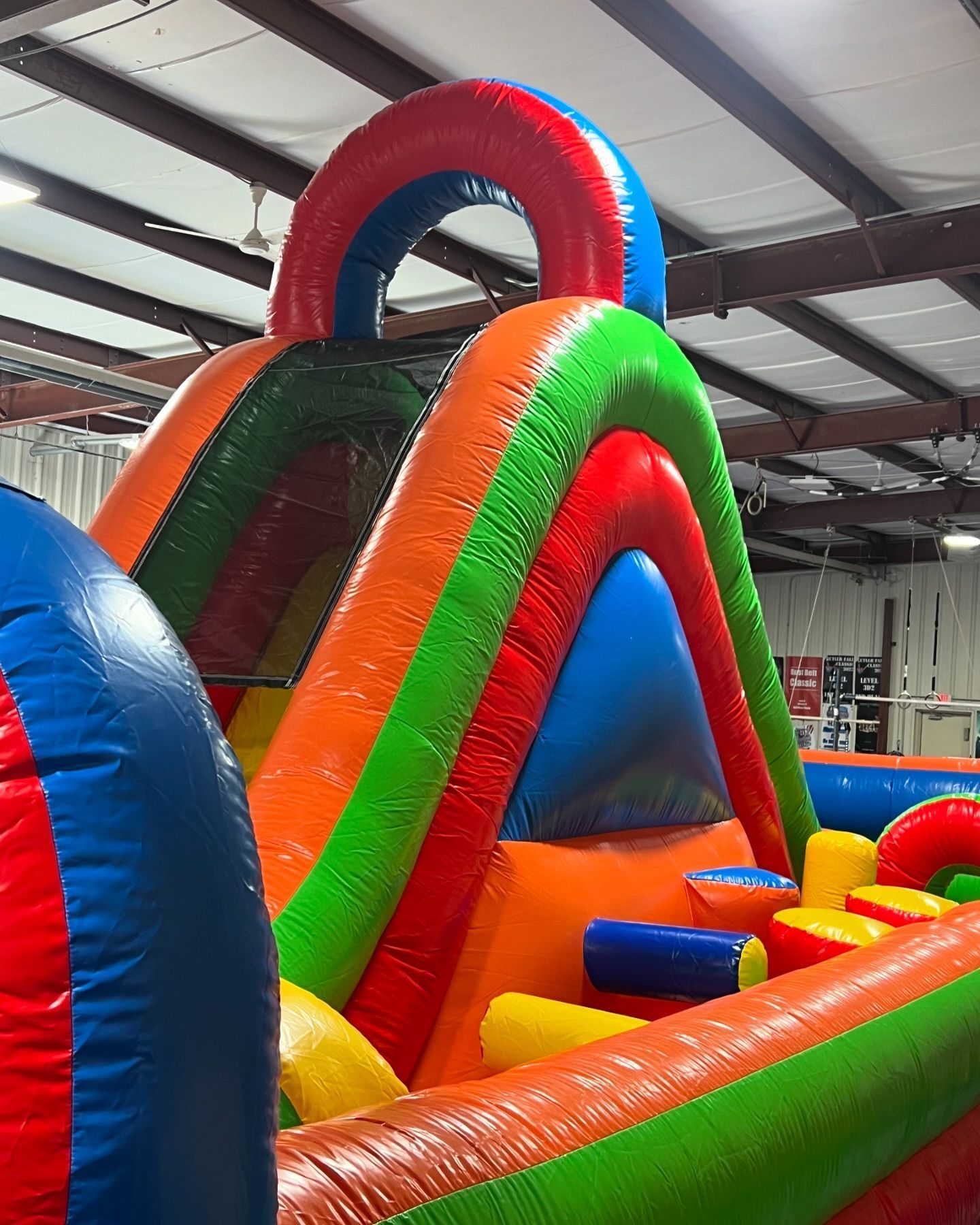 A large colorful inflatable obstacle course in a building