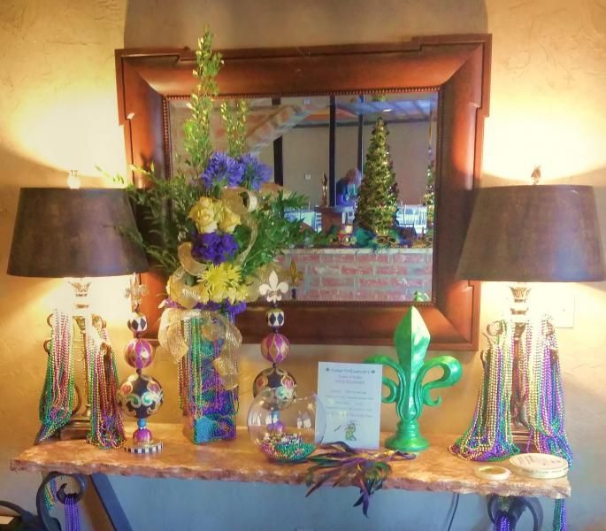 A table with two lamps and a vase of flowers on it