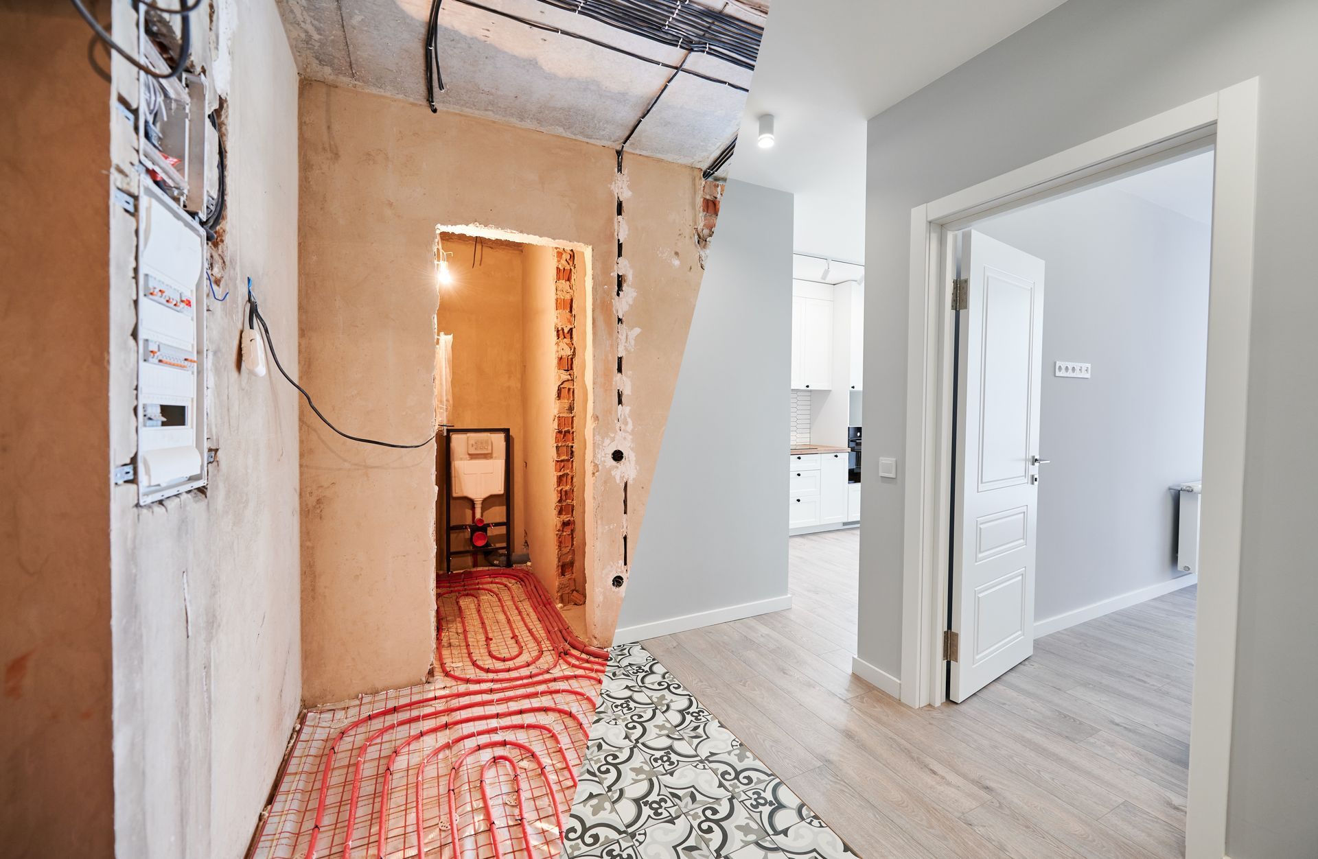 A hallway in a house under construction with a rug on the floor.