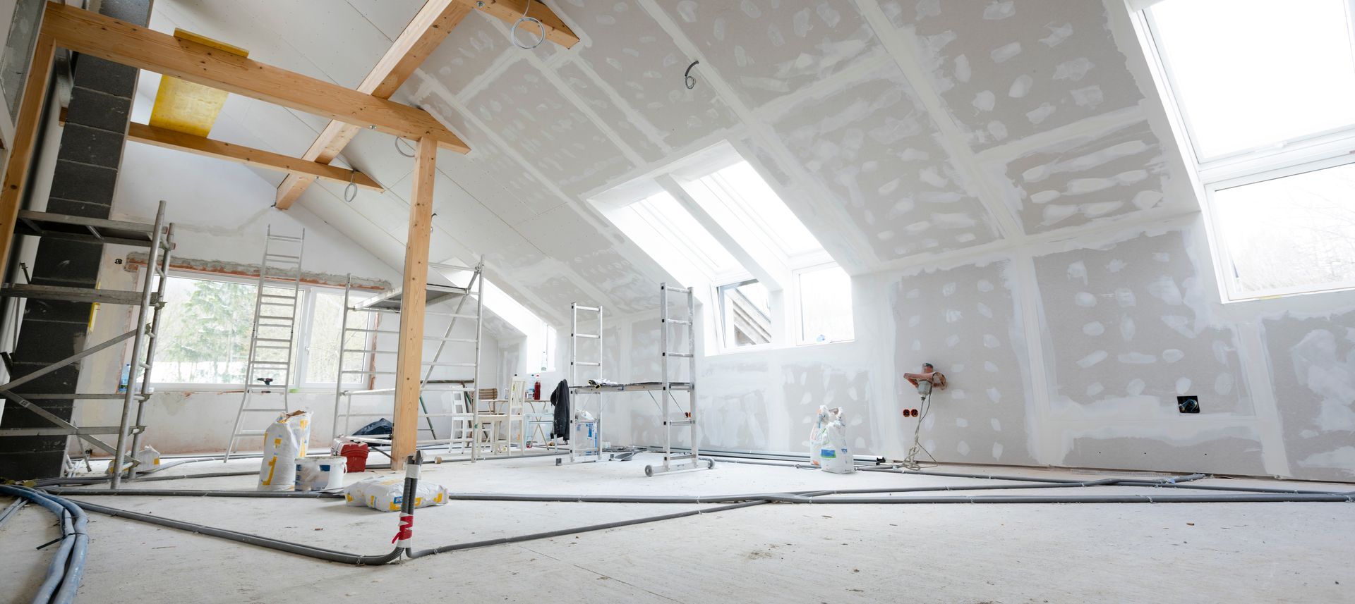 A large room with a ceiling that is being remodeled.