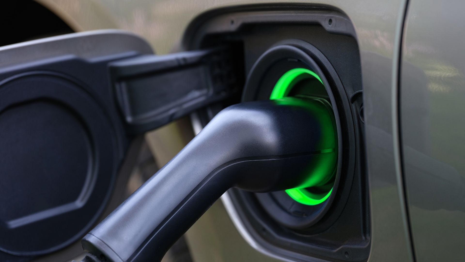 Yellow industrial generator against a dark wall, with black cables and ventilation grilles.