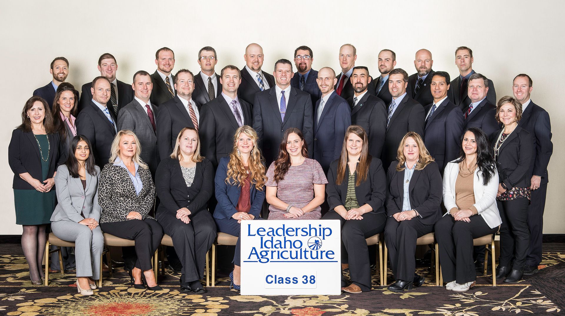 Group photo of the Leadership Idaho Agriculture Class 38 posing formally in a bright, indoor setting.