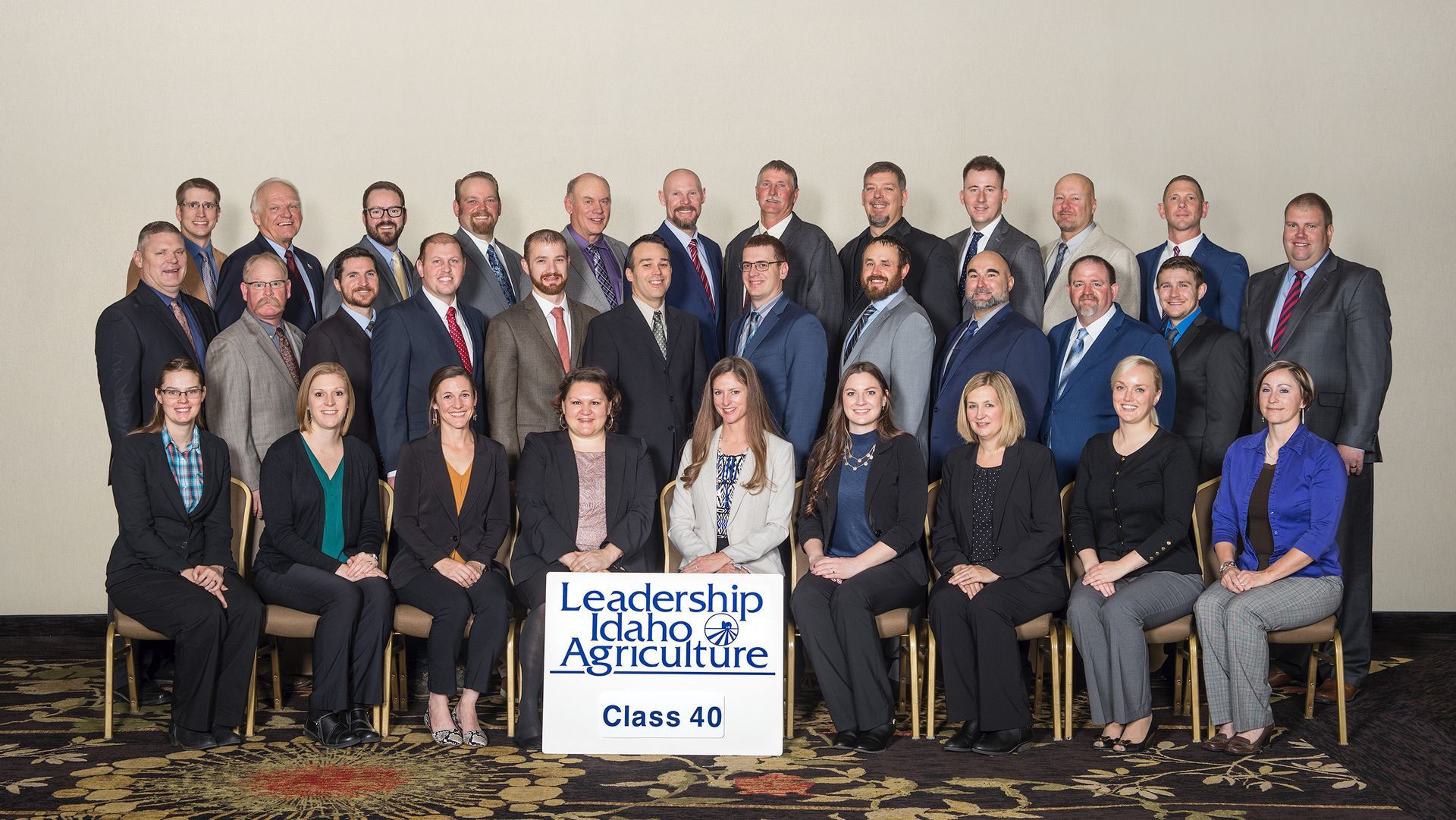 A formal group portrait of the Leadership Idaho Agriculture Class 40, posed in rows against a plain wall.