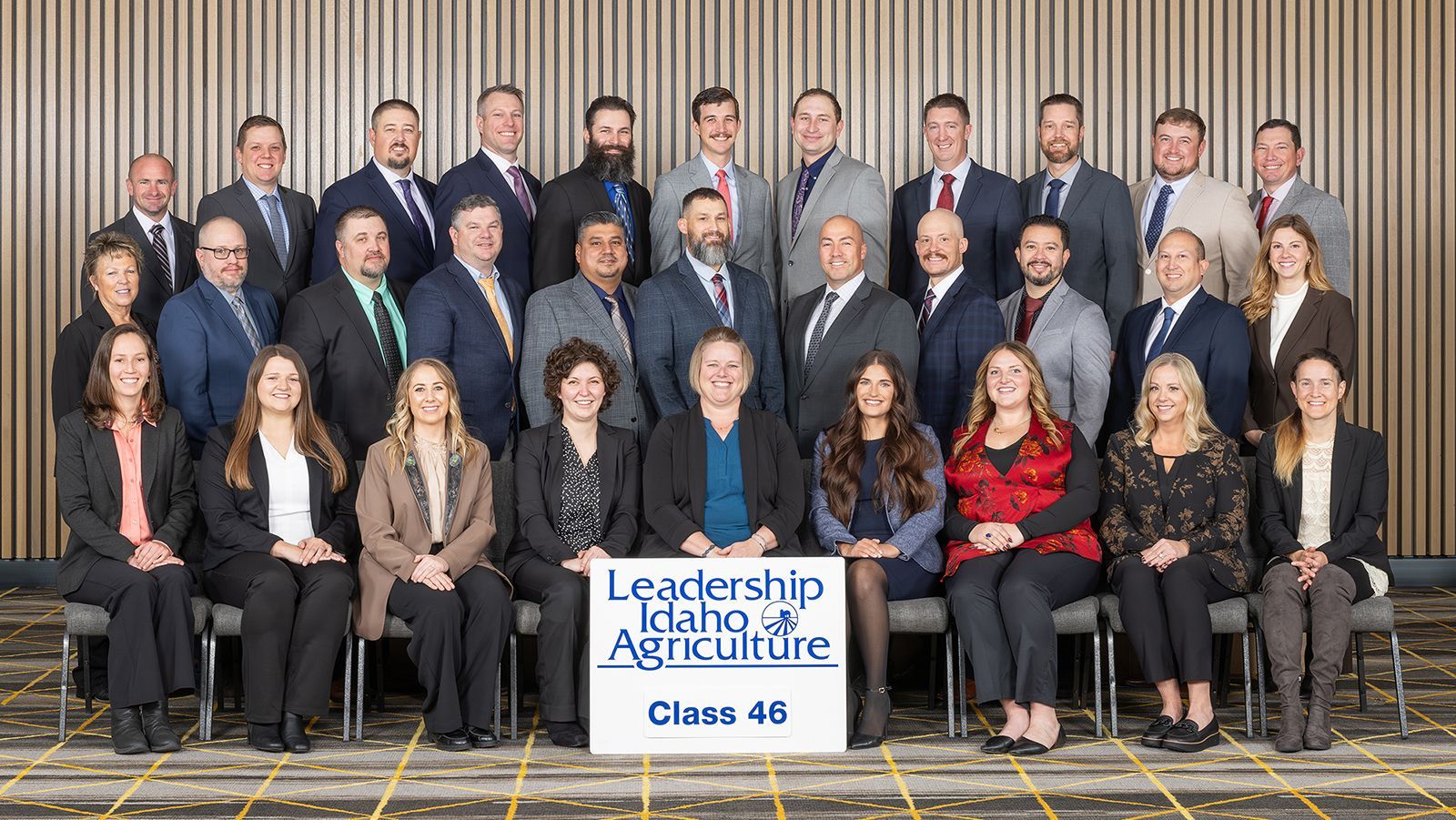Group portrait of the Leadership Idaho Agriculture Class 46 participants posing in a conference room with a sign.