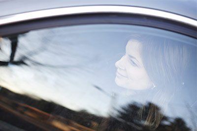 Woman in a car behind new glass
