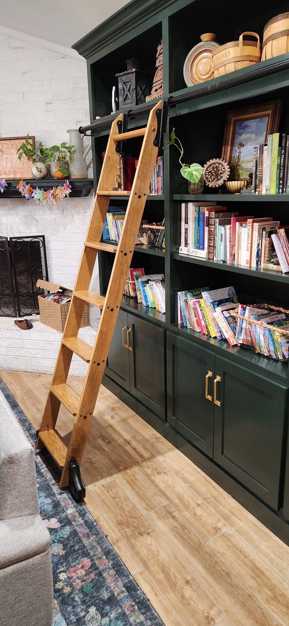 A small bathroom with white marble tiled shower and black pebble floor. A toilet is on the left.