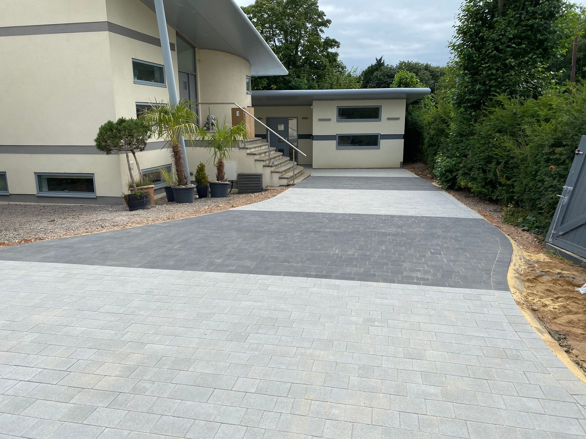 A driveway leading to a house with the letter b on it