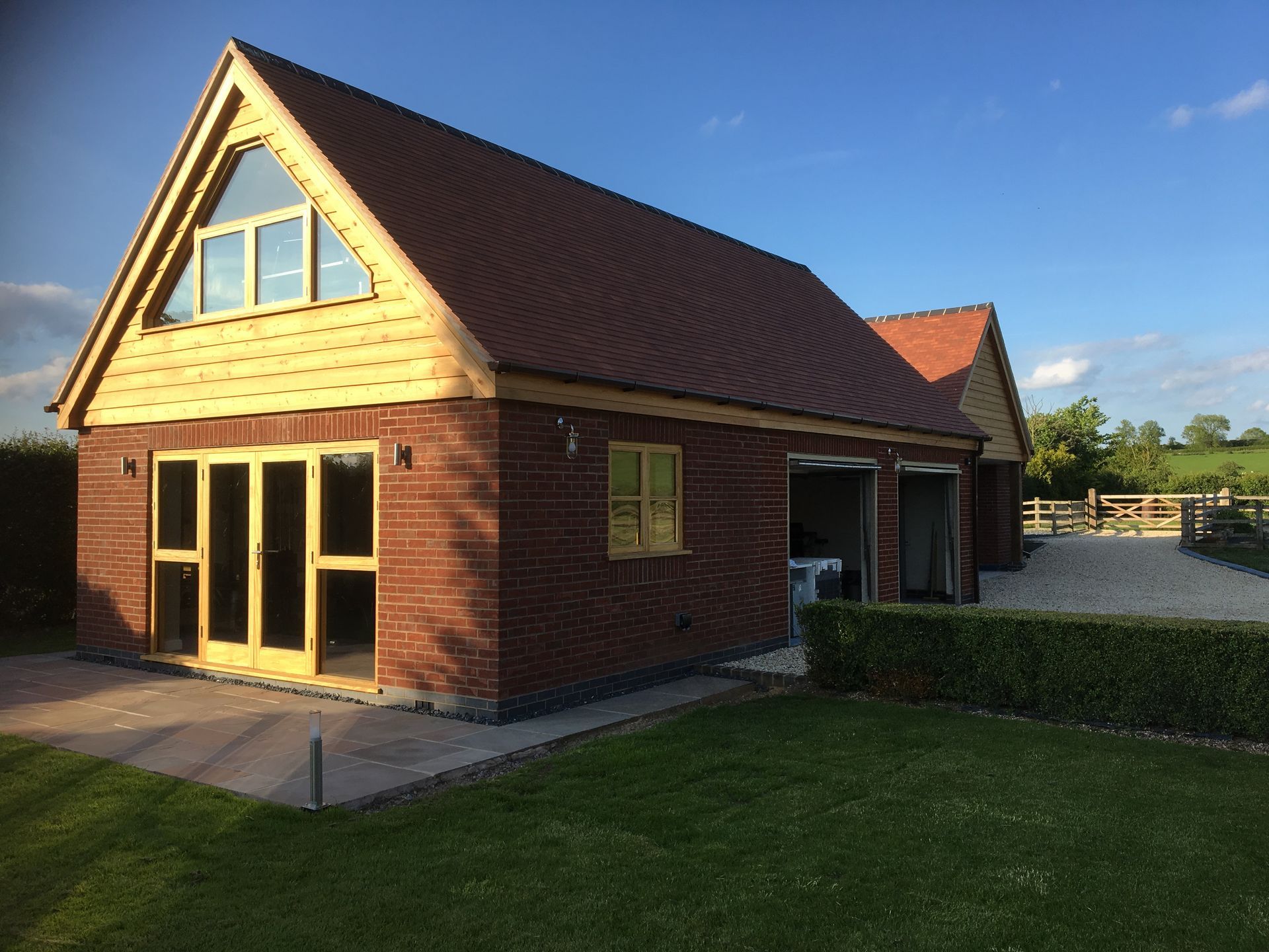 A brick house with a red roof and a lot of windows
