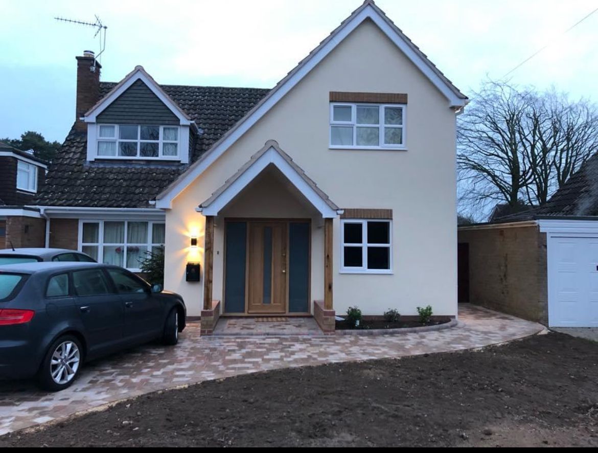A house with a car parked in front of it