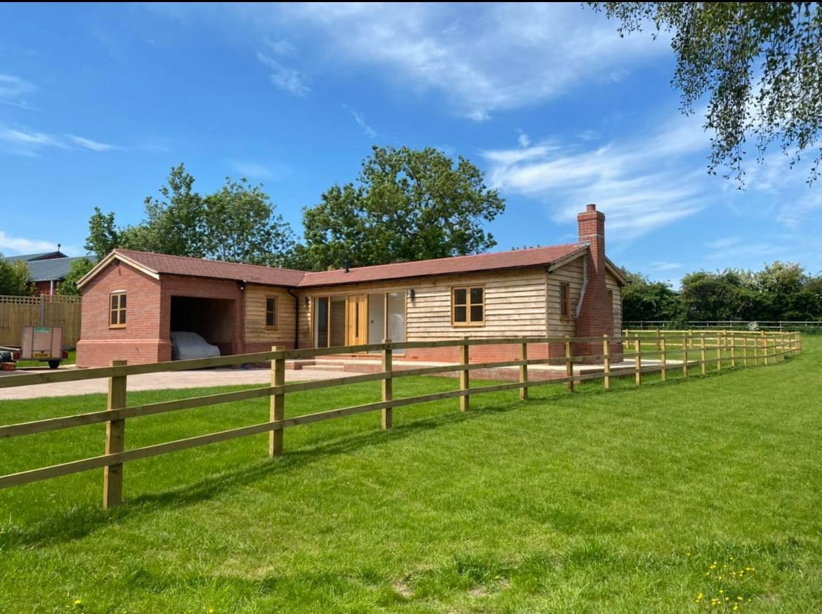 A house with a wooden fence in front of it