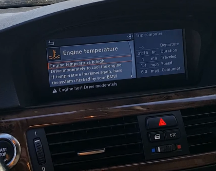A car dashboard with a screen that says engine temperature
