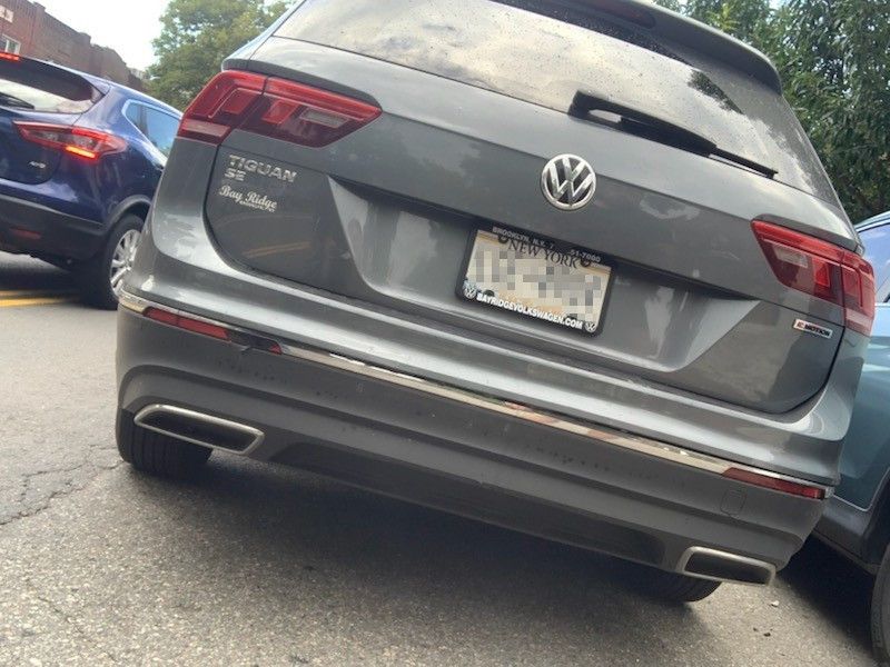 A volkswagen tiguan is parked on the side of the road