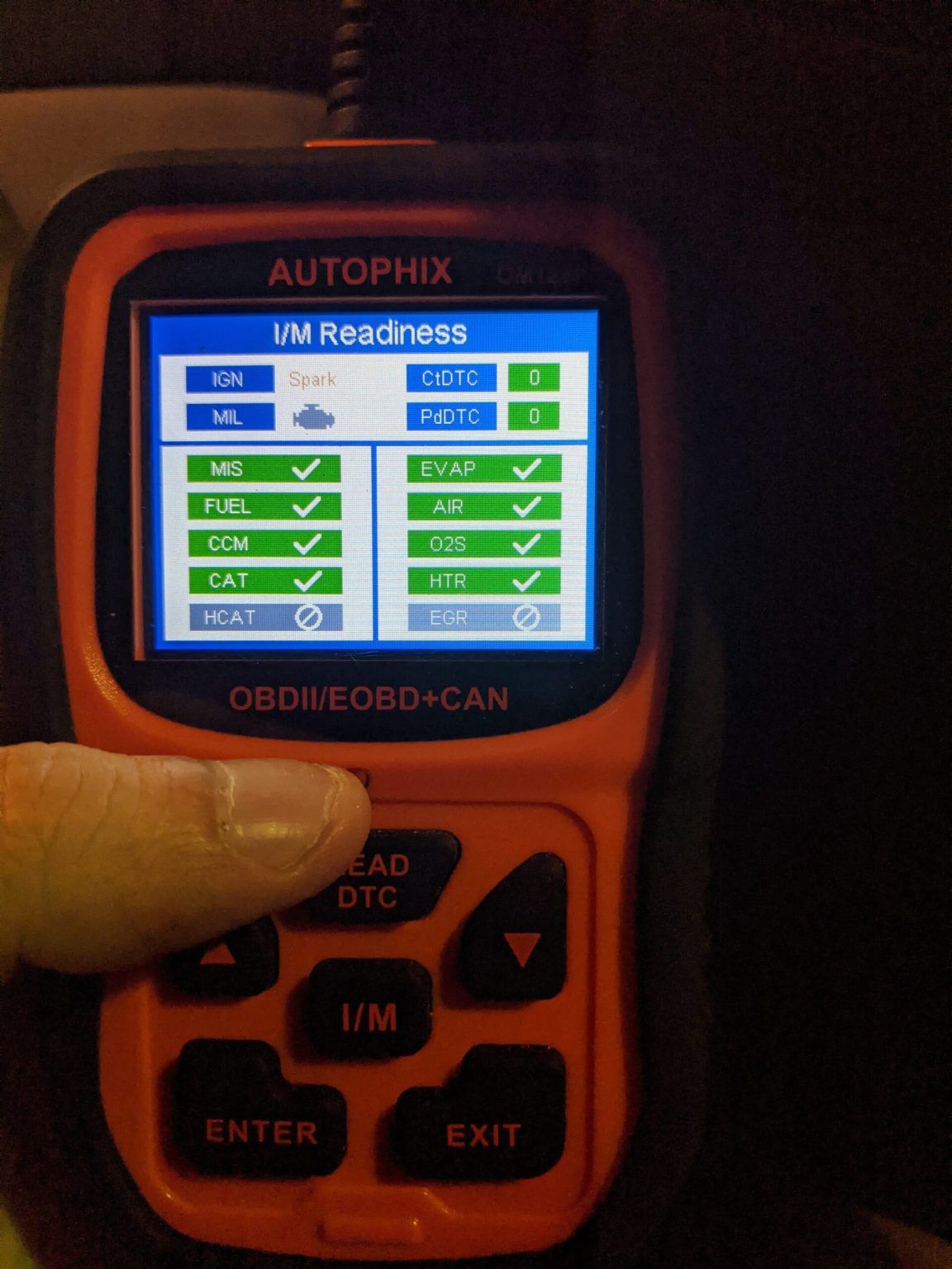 A person is holding a device that says autophix on it
