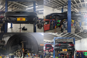 A car is sitting on a lift in a garage.