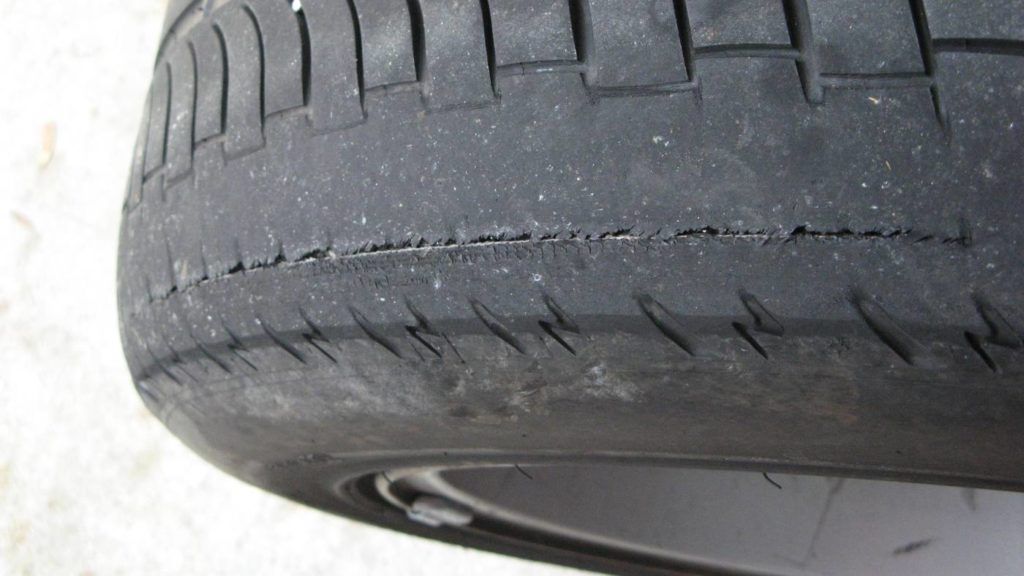 A close up of a tire with a few holes in it.
