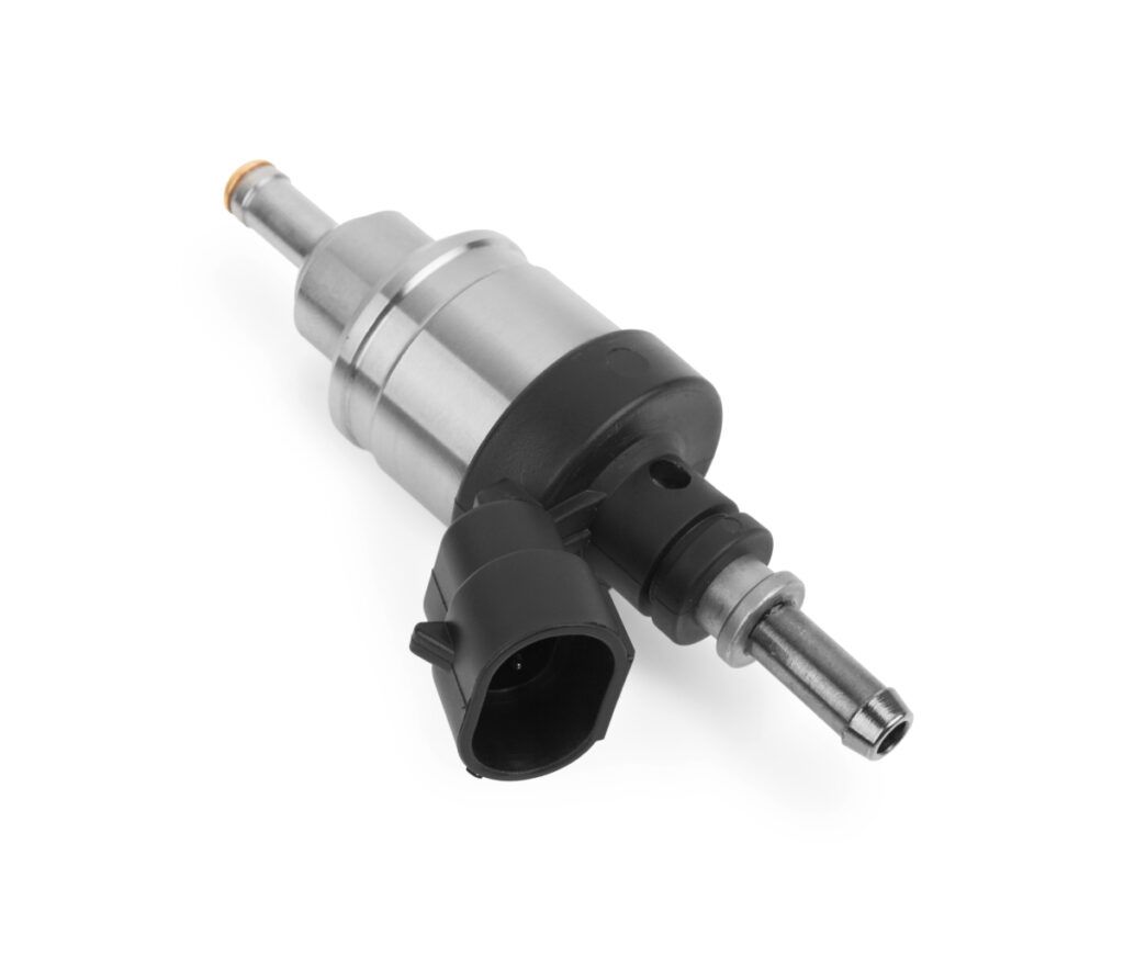 A close up of a fuel injector on a white background