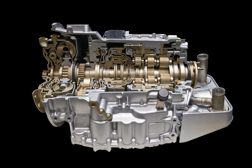 A close up of a car engine on a black background