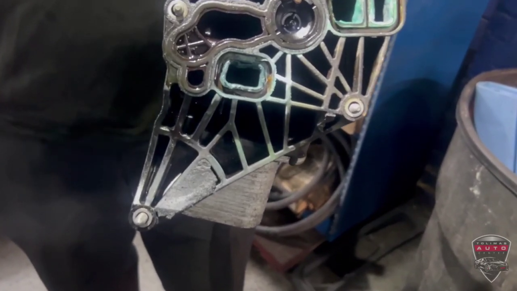A person is holding a piece of metal in their hand.