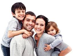 Een gezin poseert samen voor een foto en lacht naar de camera.