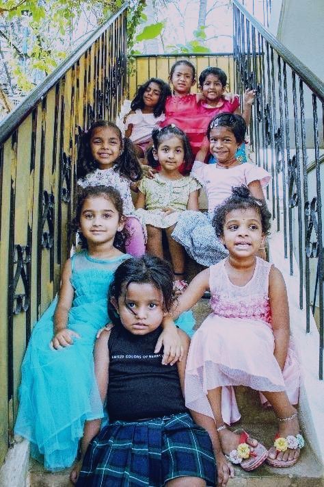 Children sitting on the staircase at Montessori in Bengaluru.