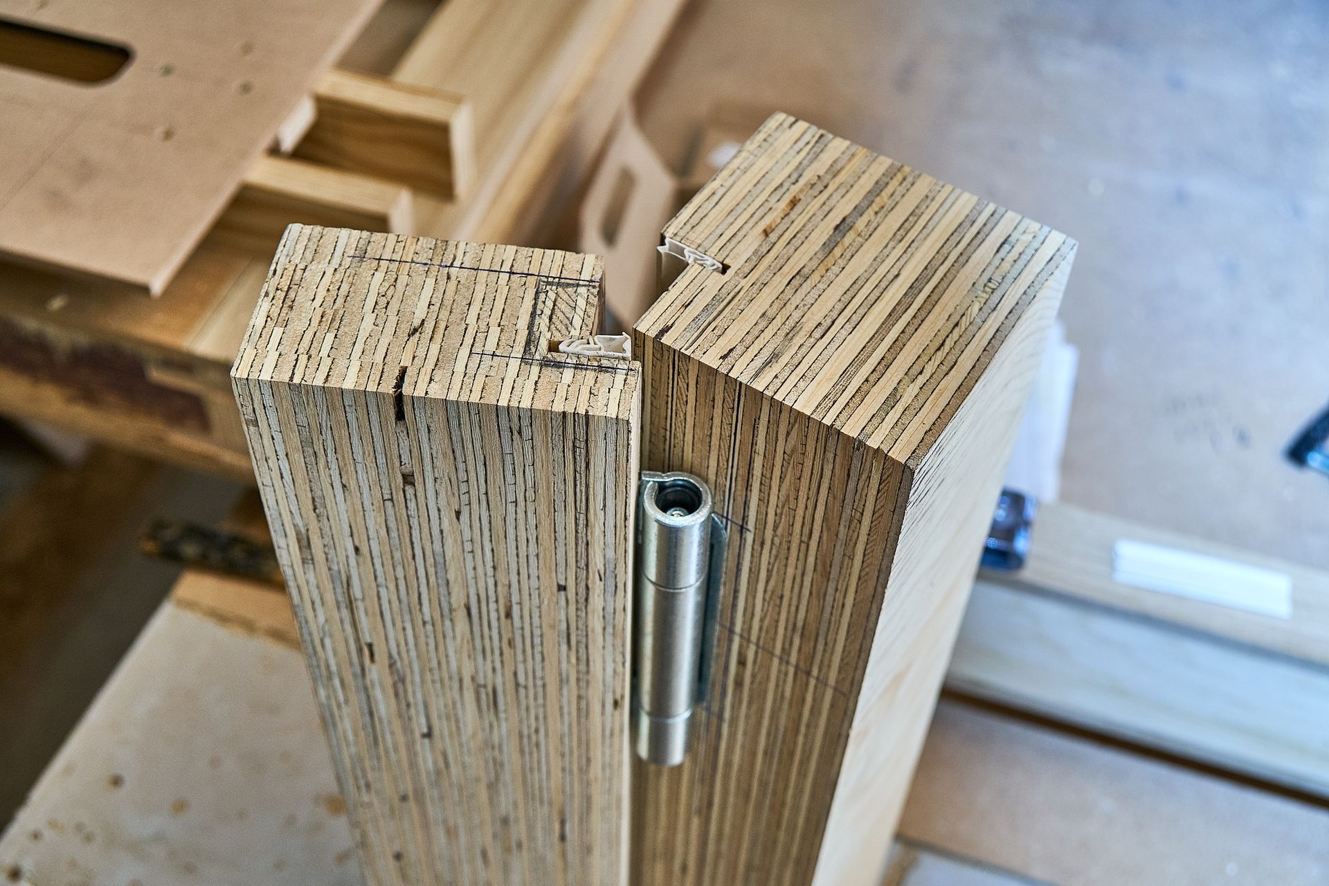 A piece of wood with a metal screw in it is sitting on a table.