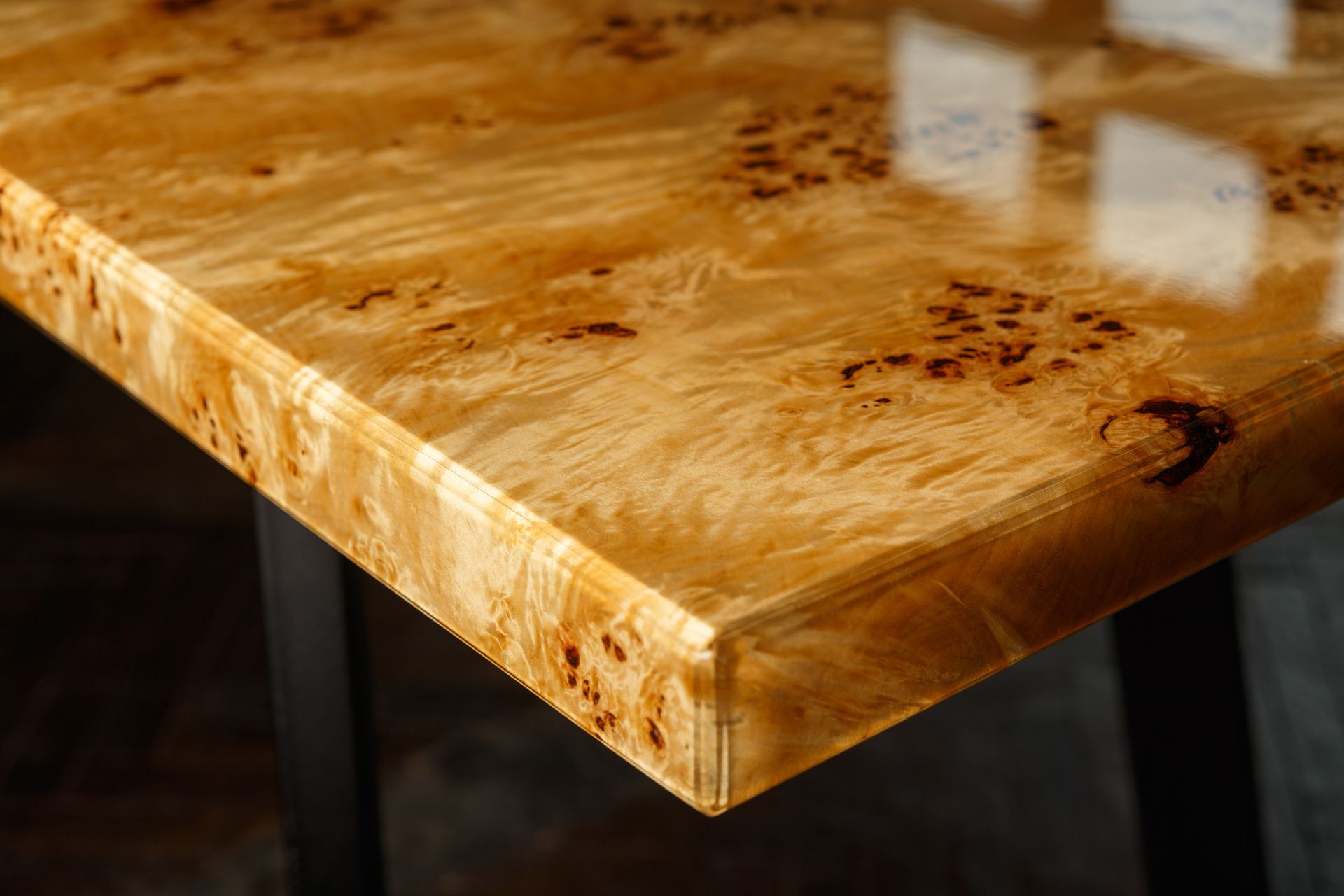 A close up of a exotic wooden table with a shiny finish.