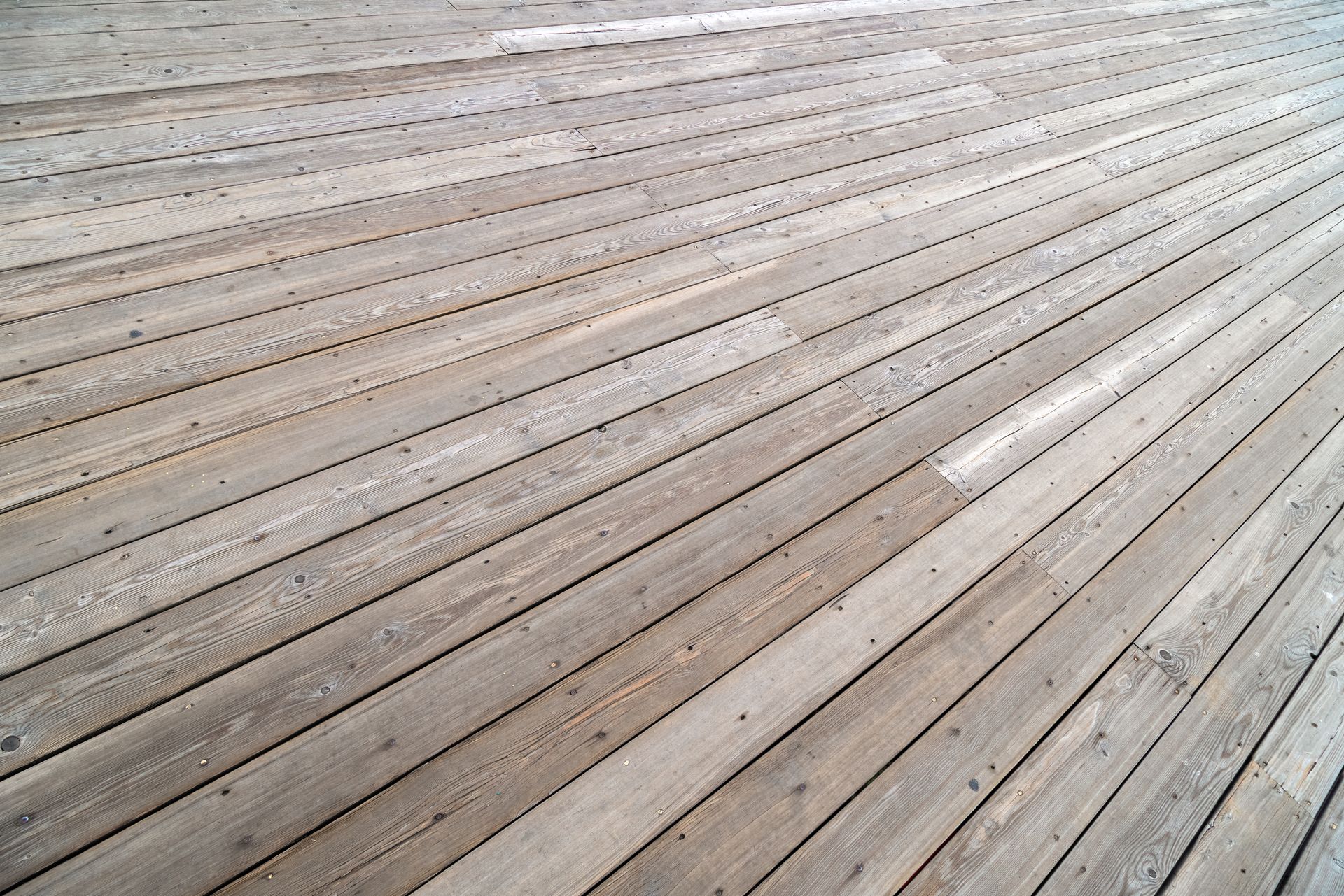 A close up of a wooden deck with a diagonal pattern