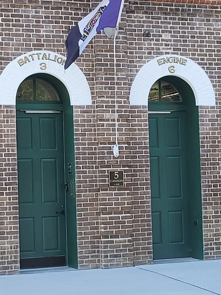 A room with three white doors and a wooden floor.