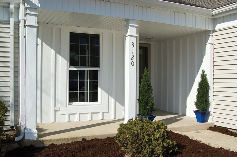 The front door of a building with stairs leading up to it