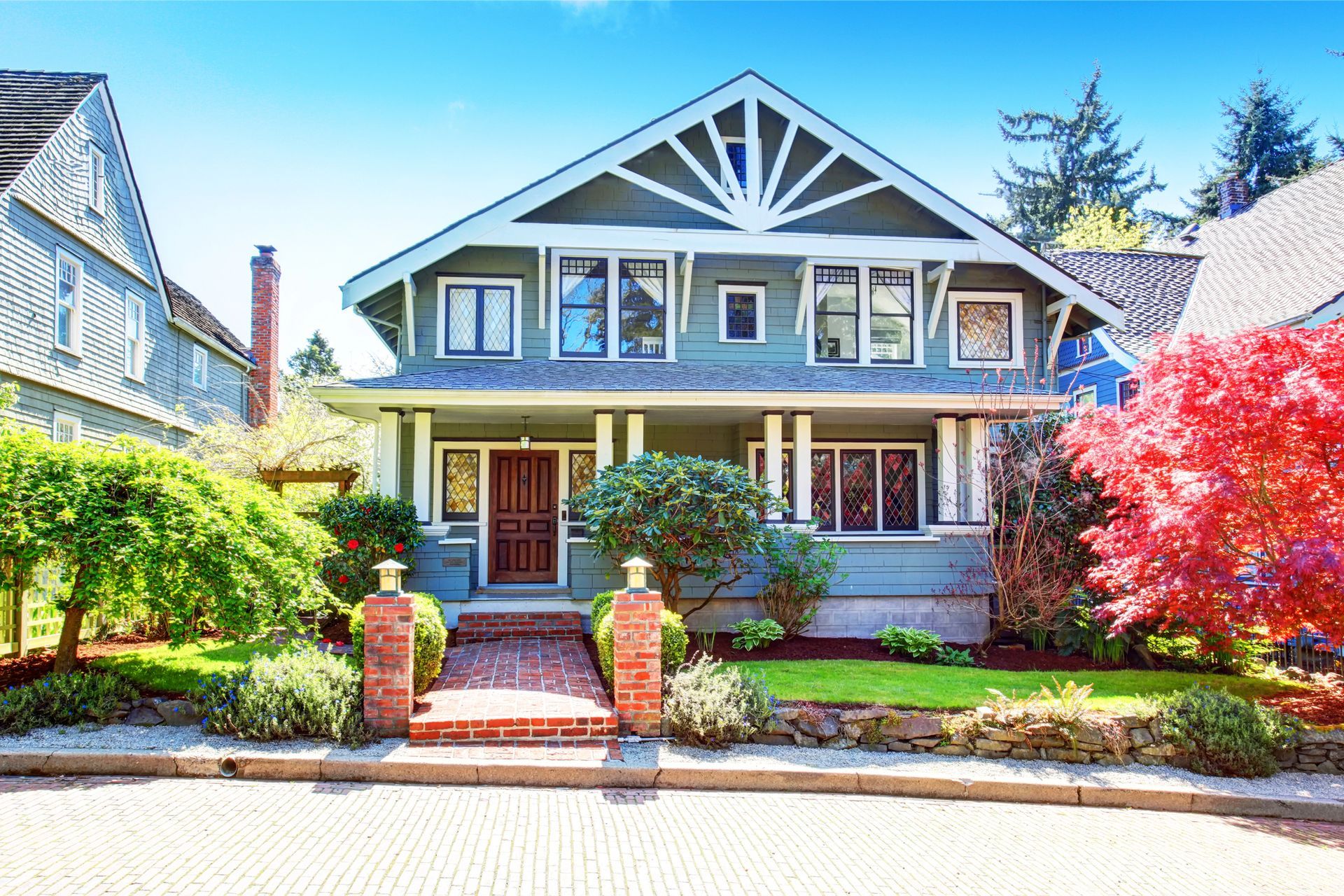 A log cabin has a large deck with a table and chairs on it.
