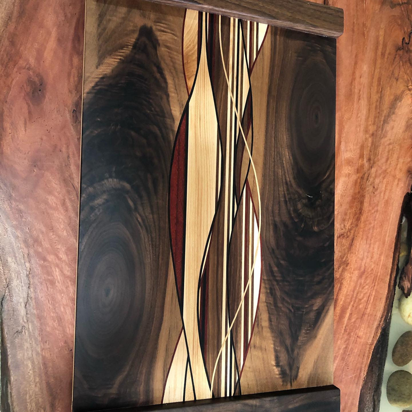 A piece of wood with a pattern on it is sitting on a wooden table.