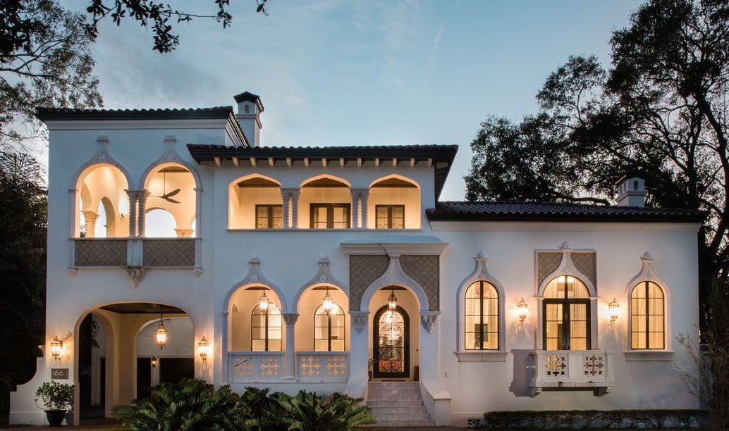 A porch with two red chairs and a mailbox