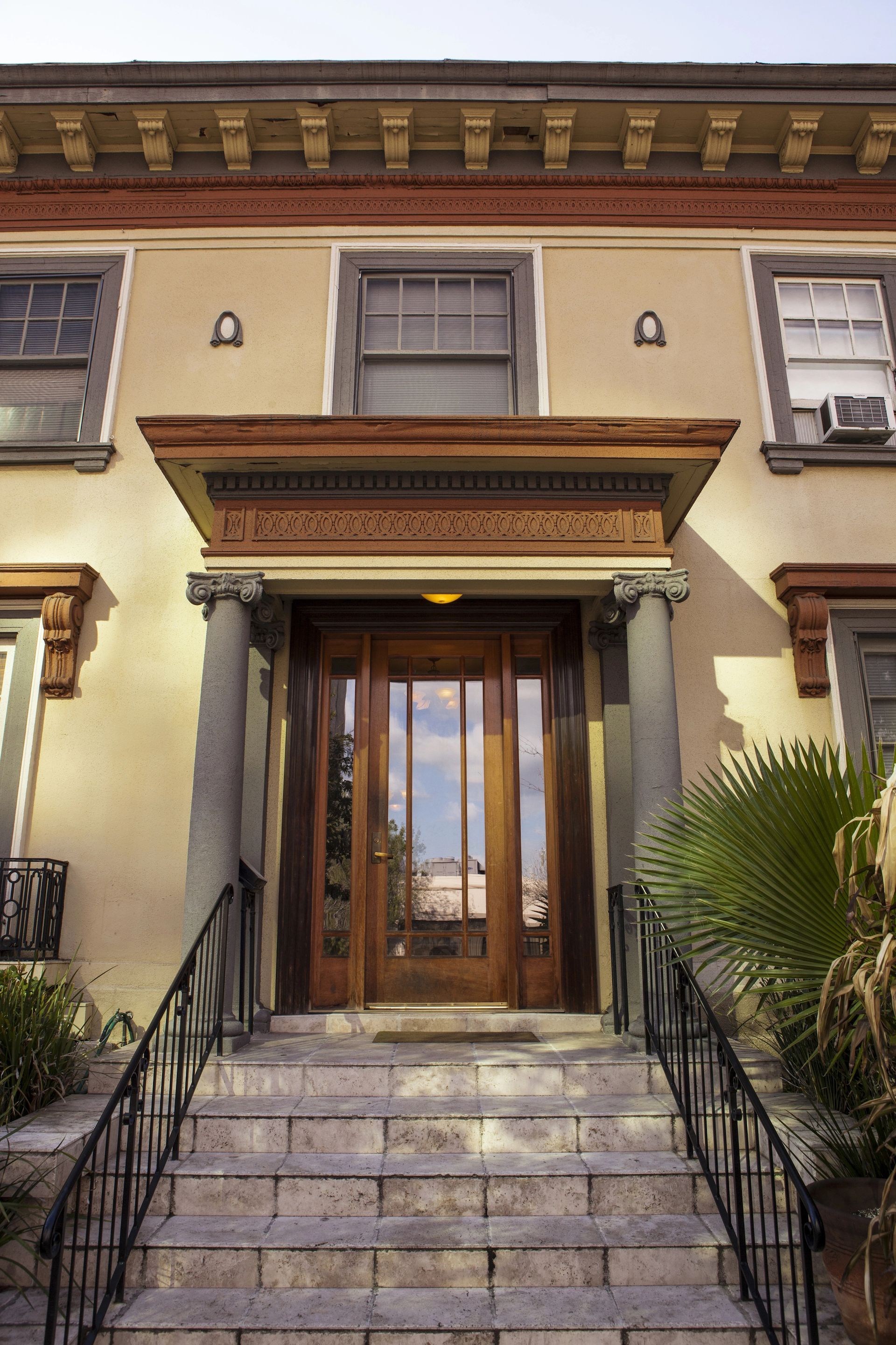 The front door of a building with stairs leading up to it
