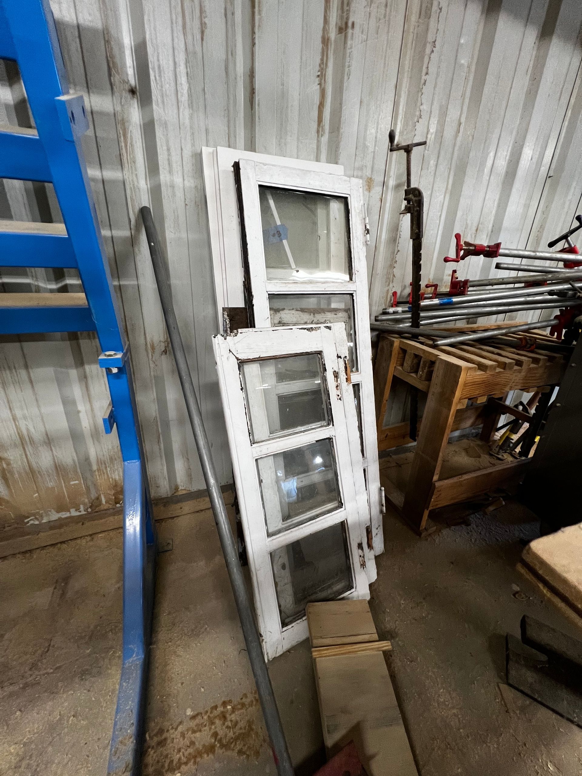 A log cabin has a large deck with a table and chairs on it.
