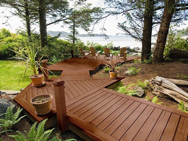A wooden deck with stairs leading to the water