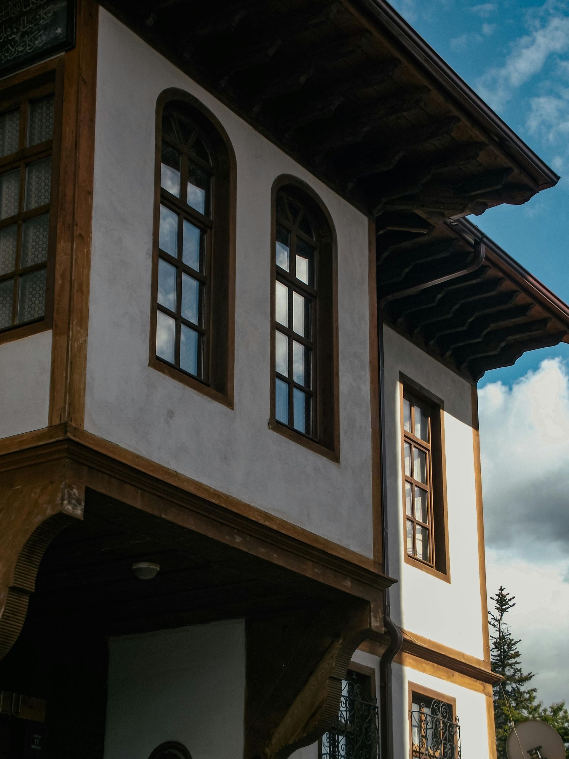 A log cabin has a large deck with a table and chairs on it.