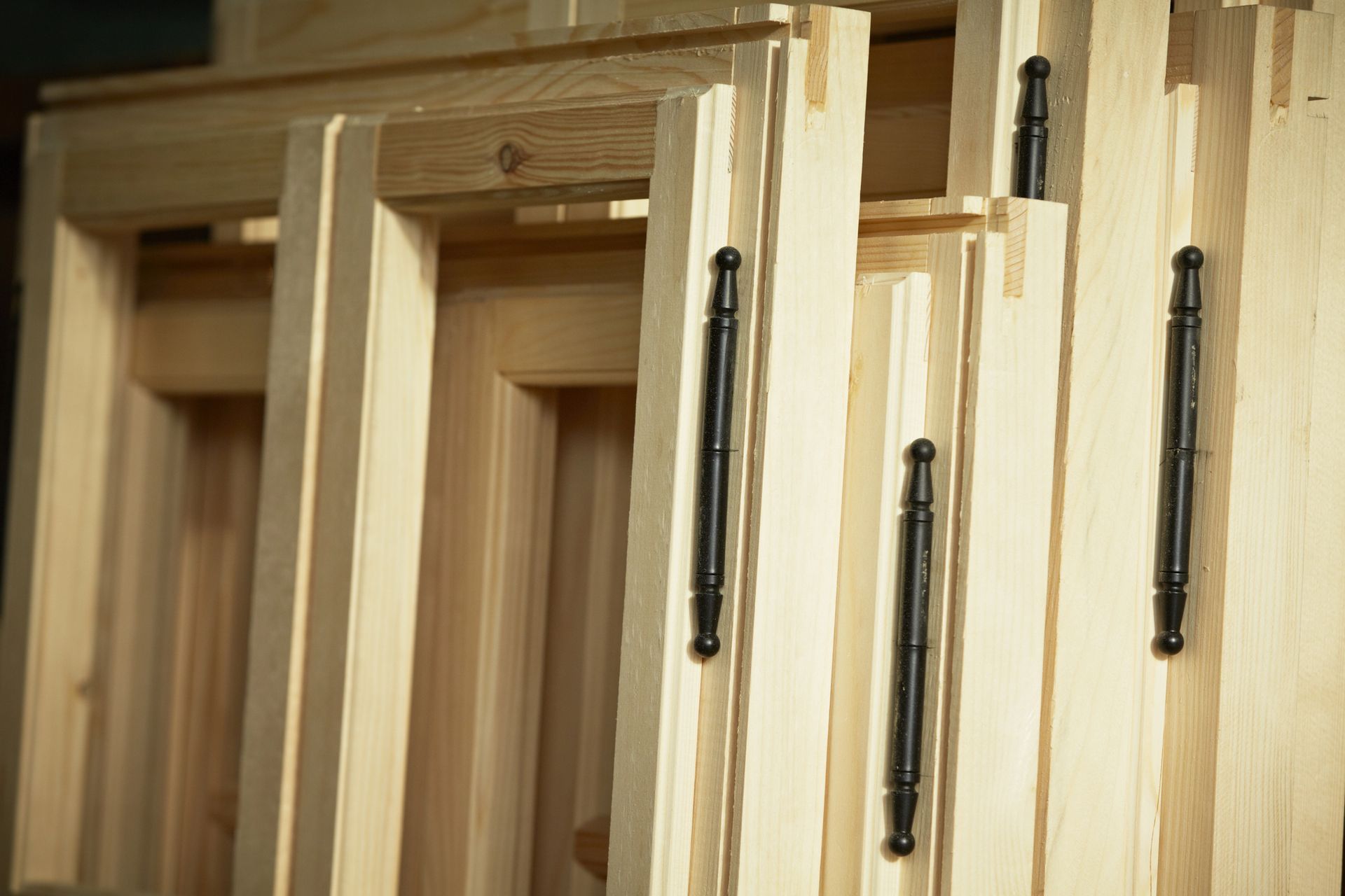 A wooden deck with chairs and a table on it surrounded by trees.