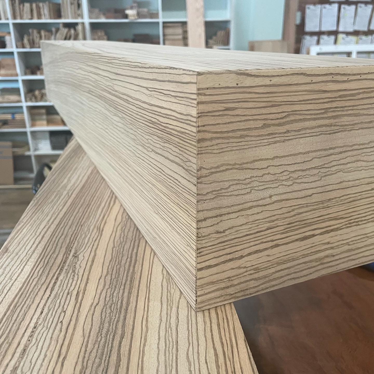 A piece of wood is sitting on top of a wooden table.