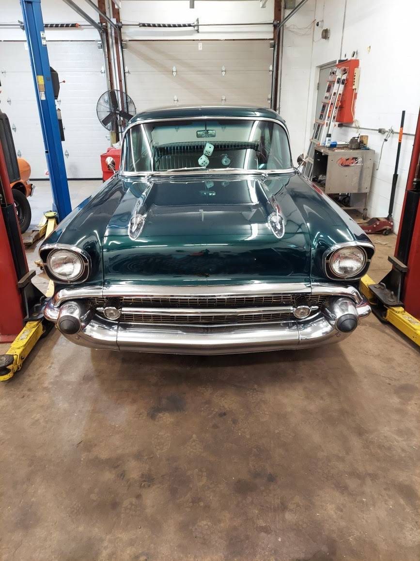 Green classic car, front view, in a garage, shiny chrome bumper. | Dave Muller Automotive & Trailer