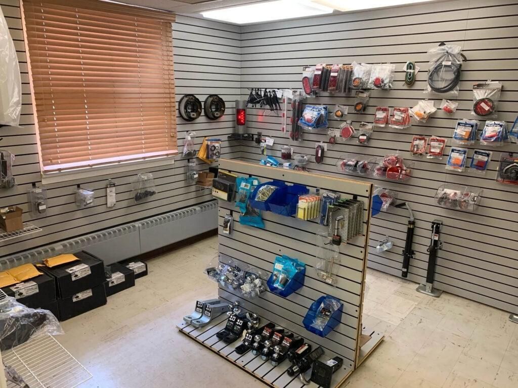 A small shop interior with products displayed on slat walls and a central display rack. | Dave Muller Automotive & Trailer