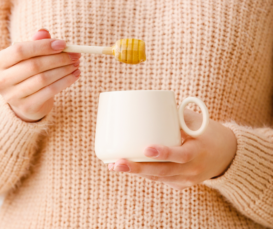 Lake Highlands Honey on a wooden honey dipper, about to go into a mug of hot wonderfulness.