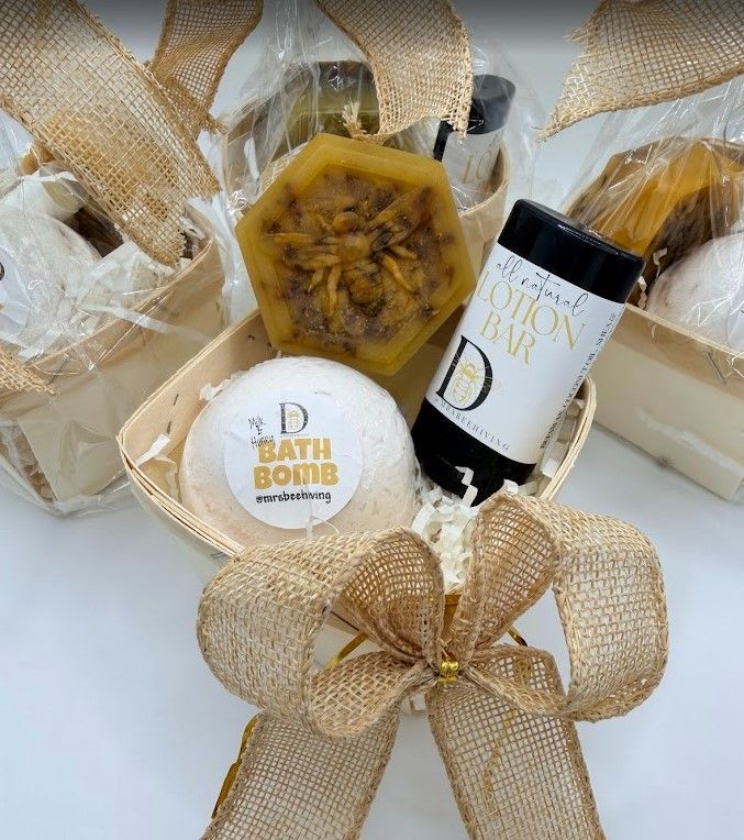 Beeswax Body Care Gift Set with honey bath bomb, lotion bar, and handmade soap in a kraft gift basket